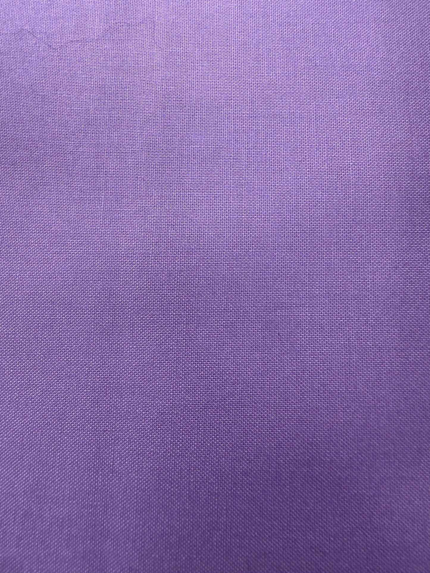 A close-up of a purple woven fabric