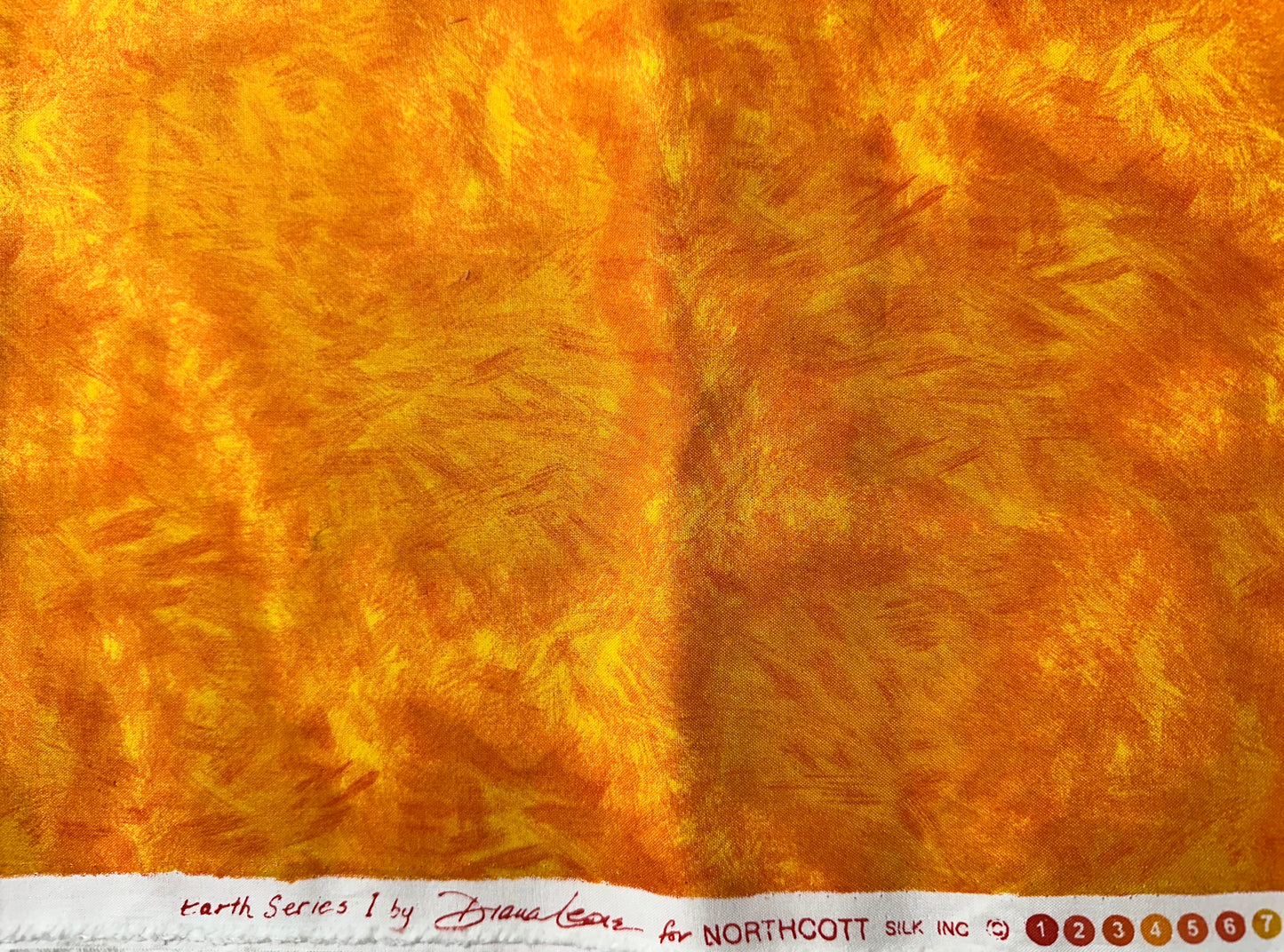 Close-up of textured yellow/orange fabric.