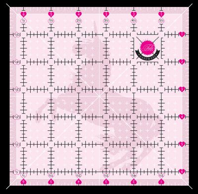 Pink square ruler with measurement markings and an unicorn logo on a pink background