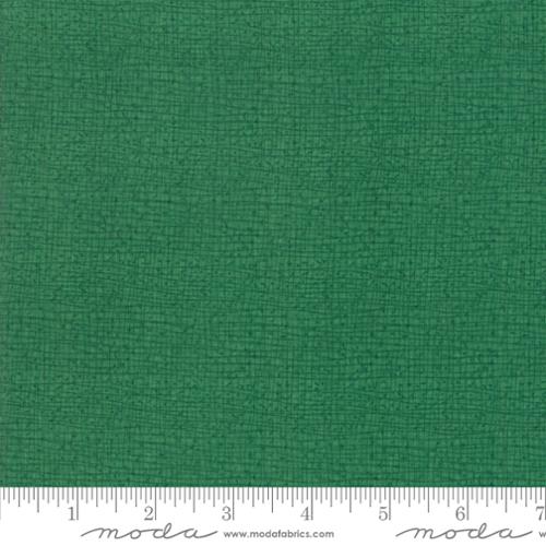 A close-up of a textured green fabric 