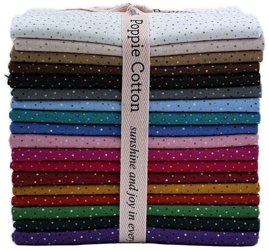 A rainbow colored stack of folded cotton fabrics in multiple colors, each with small polka dots, tied together with a beige ribbon that reads Poppy Cotton 