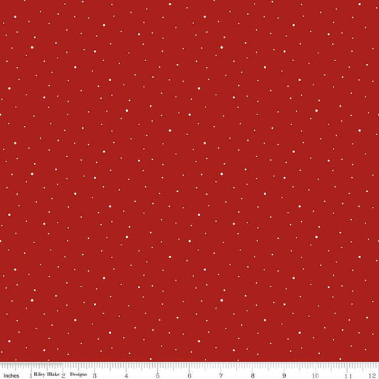 tiny white dots scattered on a barn red background