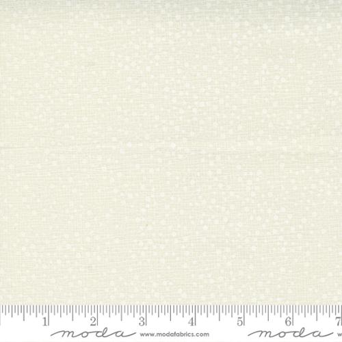 tiny white dots on a cream background