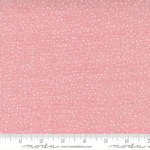 Pink fabric with a subtle  dotty pattern 