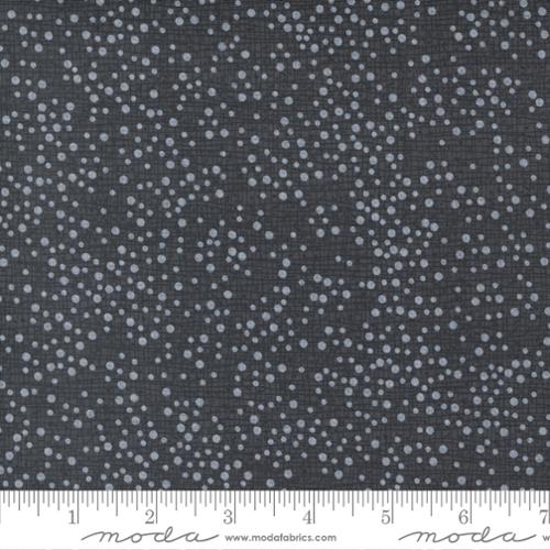 Fabric with small white dots on a dark gray background