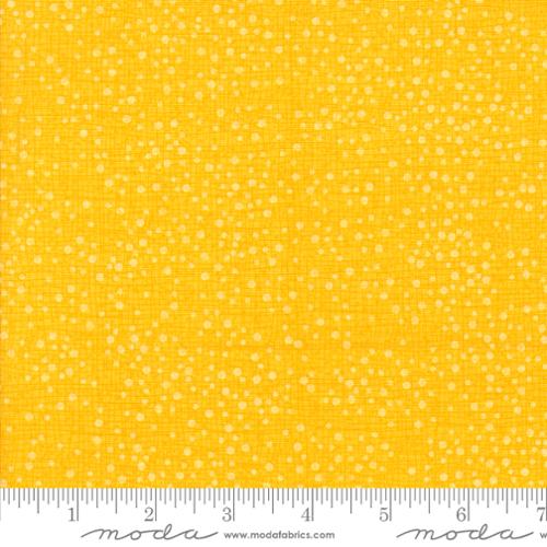 Yellow fabric with a subtle  dotty pattern 