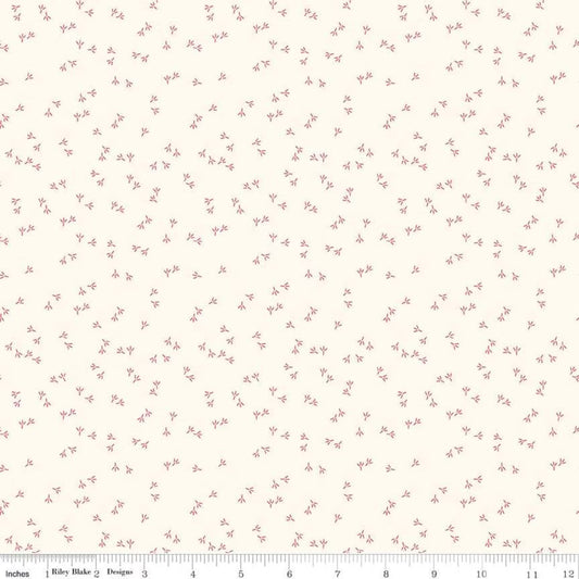 A scattered red chicken tracks motif scattered across a warm cream background