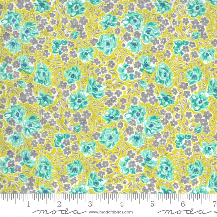 Floral fabric pattern with gray and aqua colors on a yellow background.