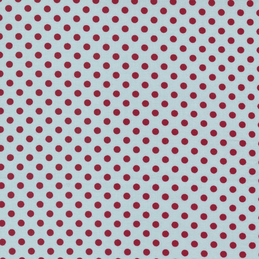 Pattern of red polka dots on a light blue background