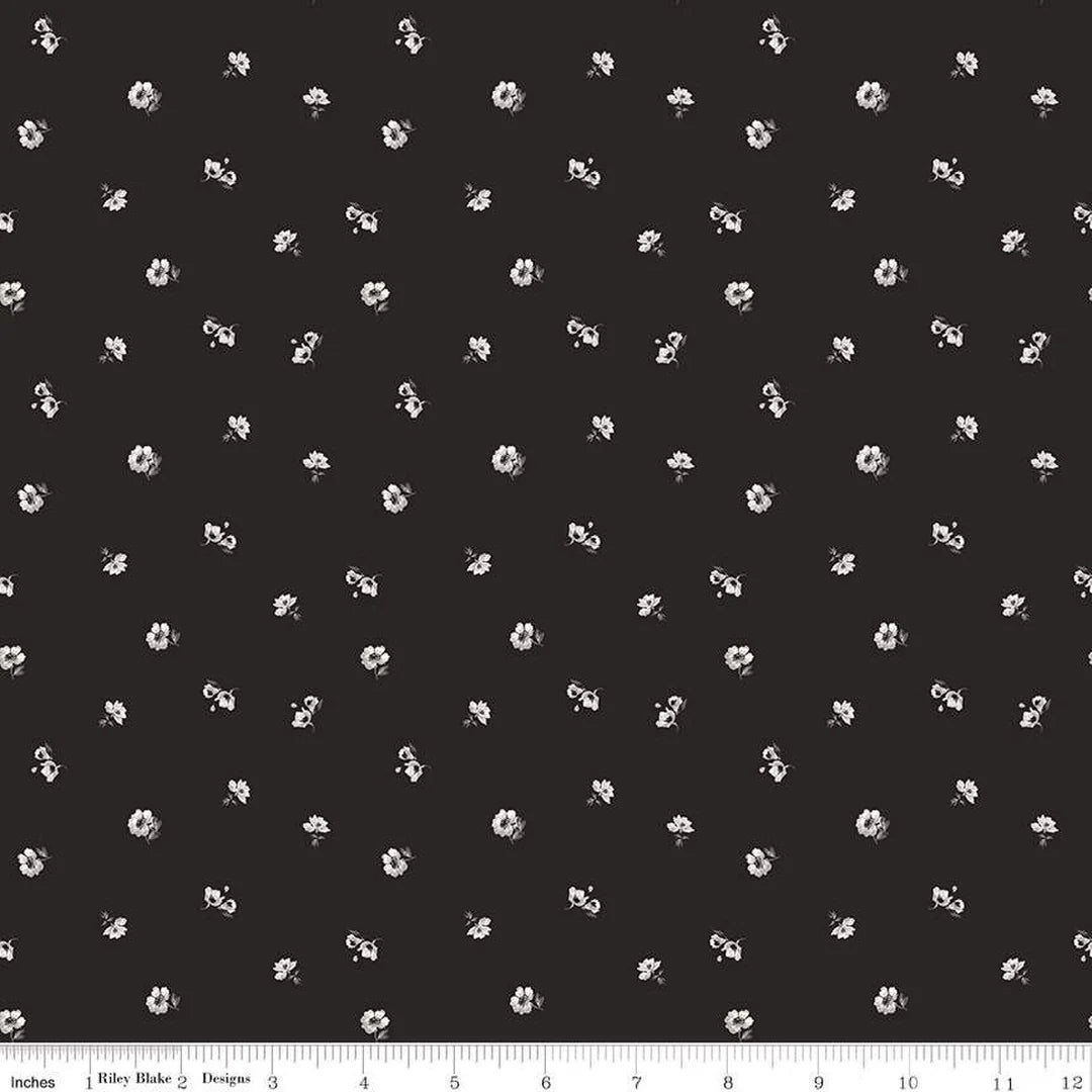 Black fabric with a repeating white floral pattern