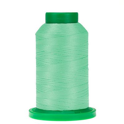 Spool of green thread with green cap and bottom of spool