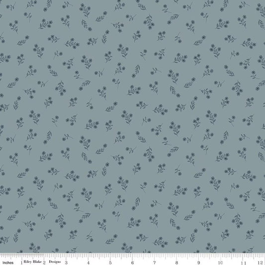A repeating floral pattern on a muted blue-gray background, with small dark blue flowers and leaves