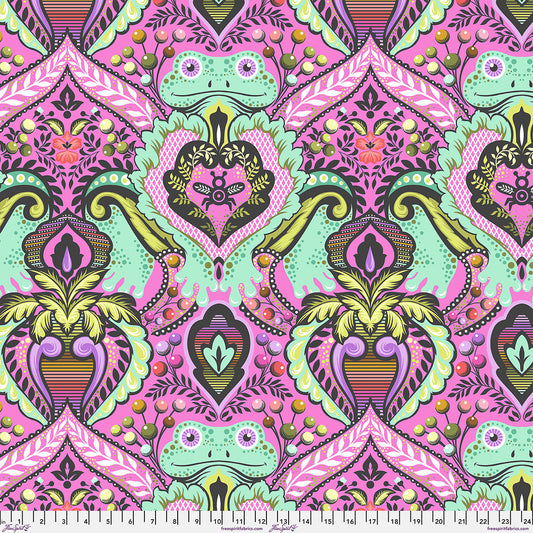 Colorful patterned fabric with frogs and geometric shapes on a pink fleece background.