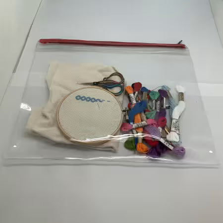 A clear zippered plastic bag . Items in shown are not included with bag