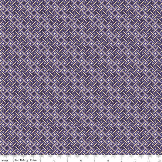 A close-up of a repeating geometric fabric pattern in purple and beige