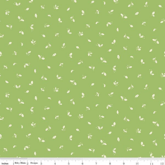 A repeating fabric pattern featuring small light green leaves and tiny floral motifs on a solid light green background